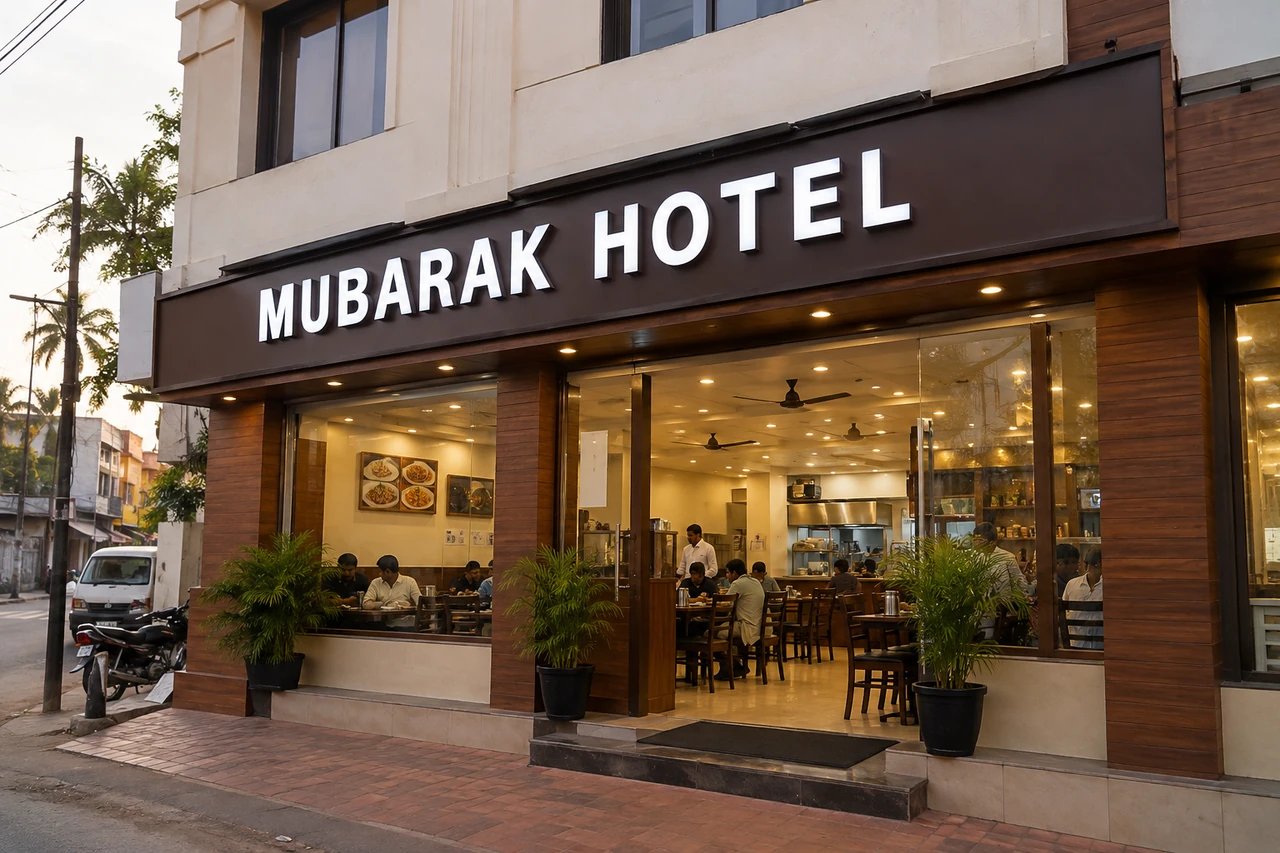 Mubarak Hotel with a glass-fronted dining area and a large white-lettered sign