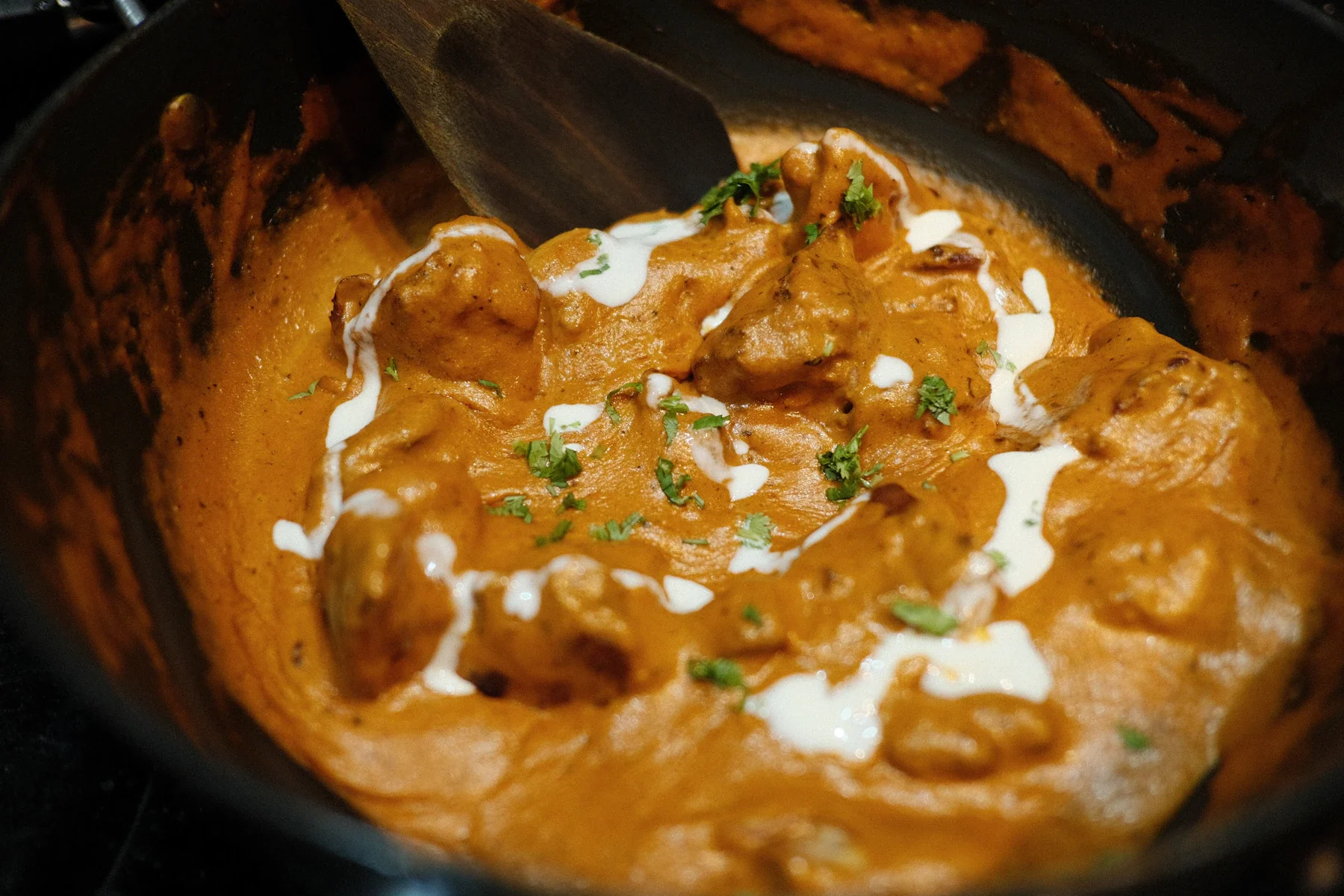 Butter chicken in a creamy tomato sauce with herbs